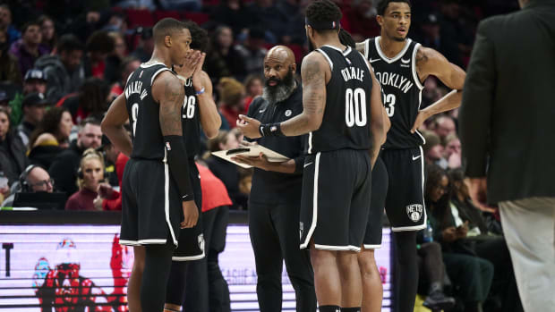 Brooklyn Nets head coach Jacque Vaughn meets with players during a time out in the second half against the Portland Trail Blazers